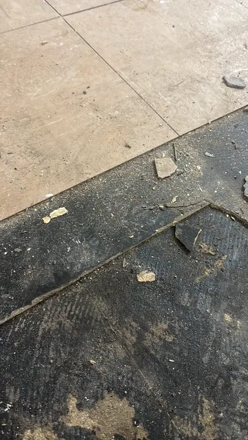 Black bitumen mastic floor removal in a SW16 flat